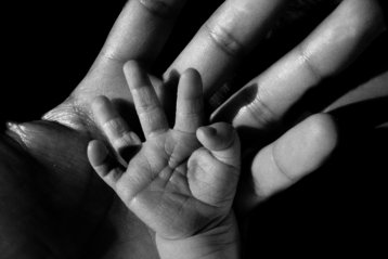 This image has an empty alt attribute; its file name is baby-and-mother-hands.jpg