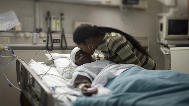 This image has an empty alt attribute; its file name is black-person-in-hospital-bed.jpg